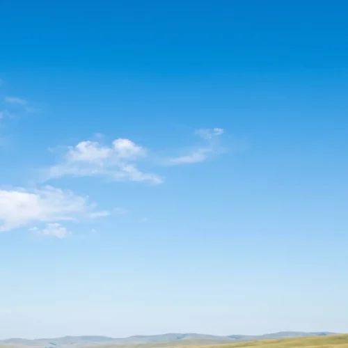 Minimal Blue Sky Background with Soft Clouds