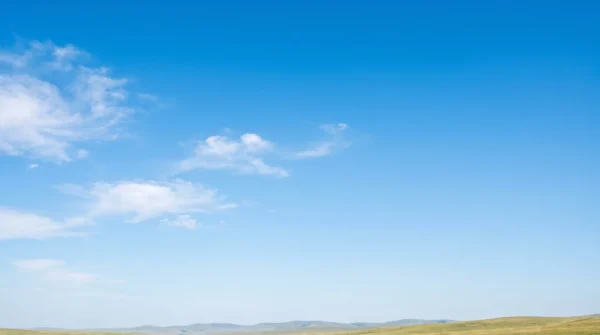 Minimal Blue Sky Background with Soft Clouds